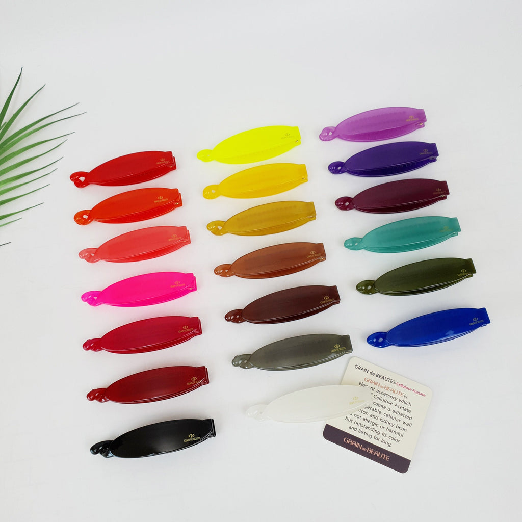 Grain de Beaute cellulose acetate banana hair clip with comb teeth in 20 vibrant solid colors. 3.3 inch non-slip ponytail holder for updos and thick hair.