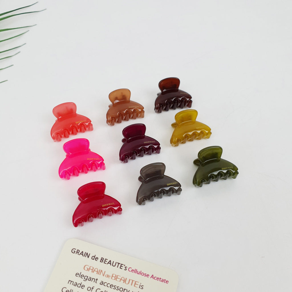 Aznavour Grain de Beaute cellulose acetate mini hair claw clip in 9 solid colors. Tiny half moon jaw clip for bangs and side hair styling.