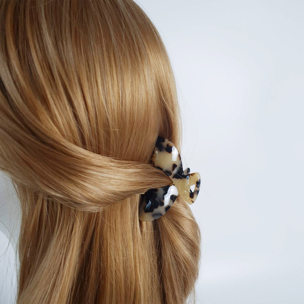 Cellulose acetate heart shaped hair claw clip in tortoise shell and marble patterns for half up hairstyles and daily wear.