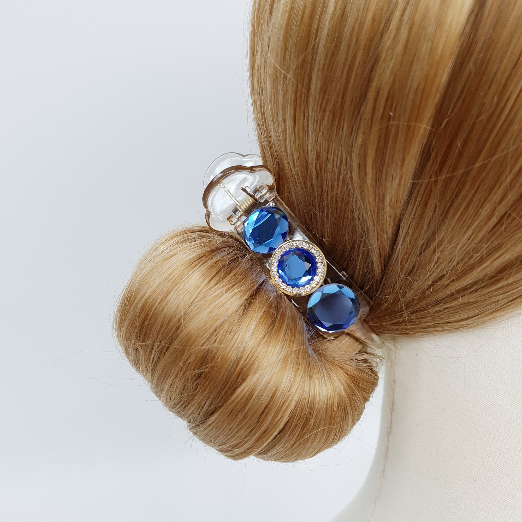 Clear acrylic cylindrical hair claw clip embellished with large faceted glass crystals. Sparkling rhinestone ponytail holder for elegant updos and half-up hairstyles.