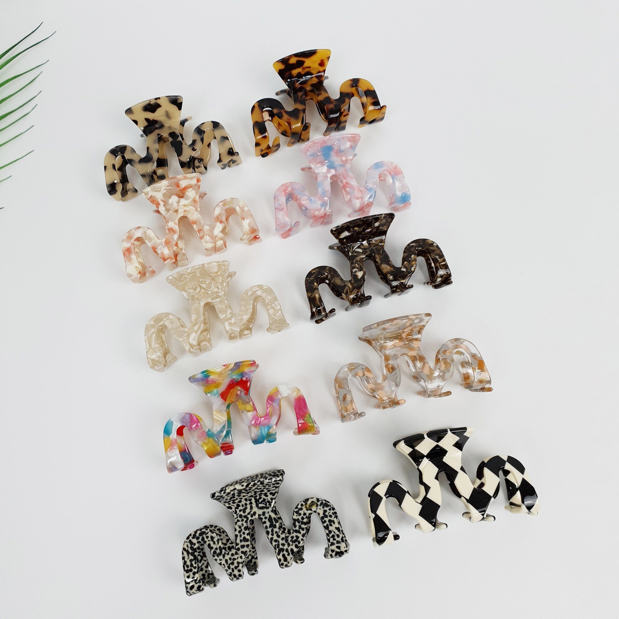 Medium cellulose acetate hair claw with a unique zigzag squiggle shape. Tortoise shell and marble pattern jaw clip designed for secure updos and half-up styles.