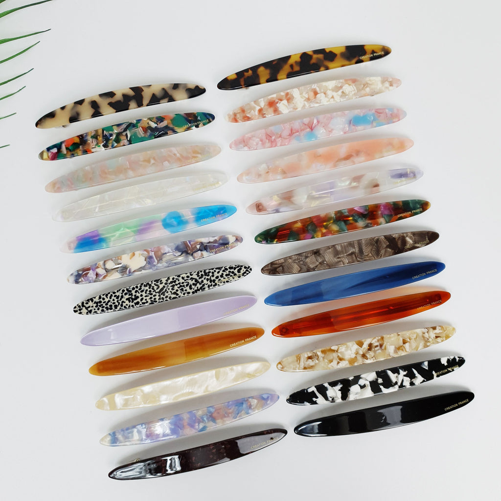 Long oval cellulose acetate hair barrette available in tortoise shell and marble patterns. 4.3 inch automatic clip for ponytails or half-up hairstyles. Elegant everyday hair accessory.