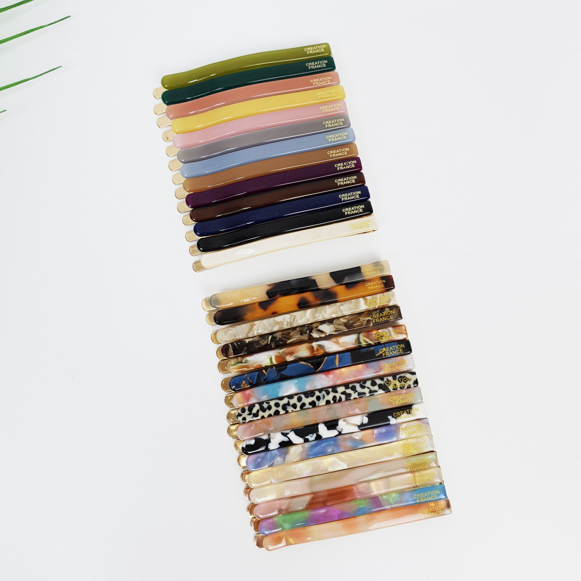 Slim cellulose acetate bobby pins with gold base, straight line tortoise shell and marble slide barrettes, minimalist side hair clips for bangs.