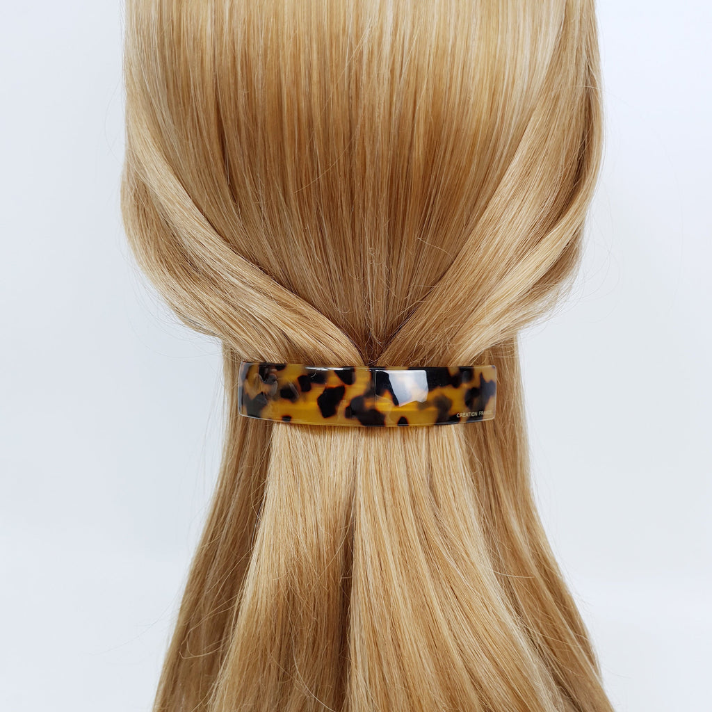 Cellulose acetate curved rectangular hair barrette in tortoise shell pattern. Automatic hair clip with inner tension bar for half-up hairstyles.