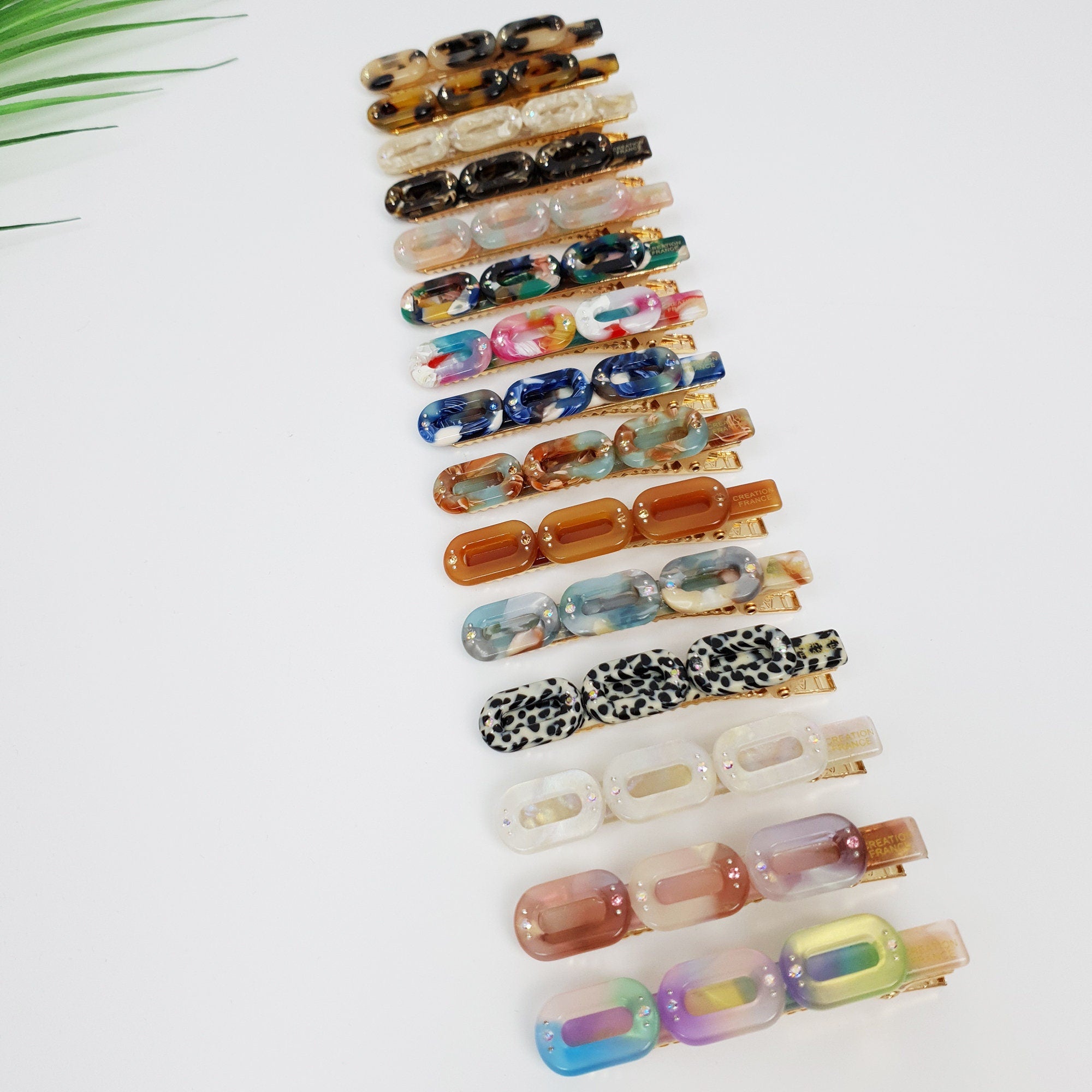 Triple chain link cellulose acetate hair clip with cubic zirconia accents. Small 2.6 inch alligator clip for side hair in tortoise shell and marble patterns.