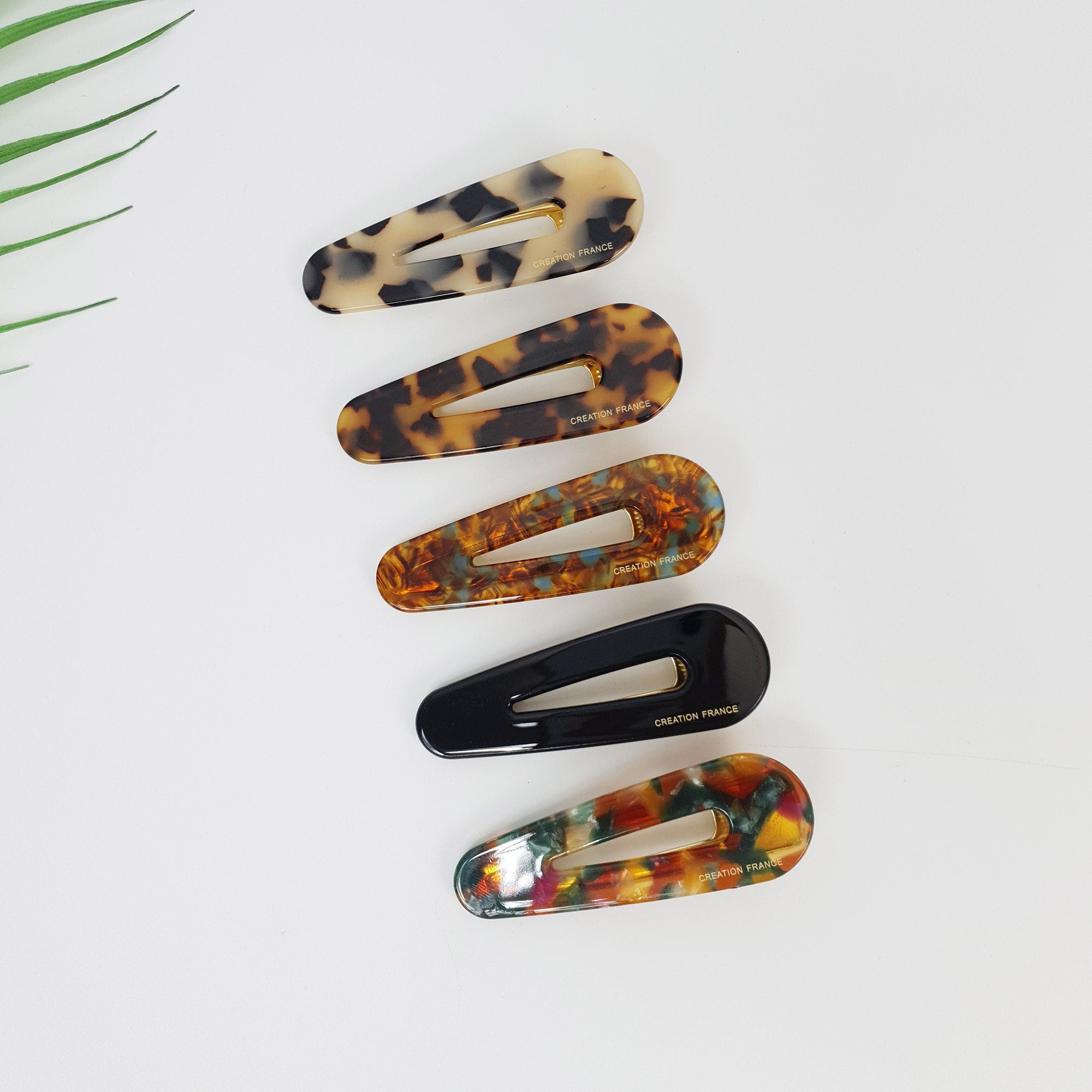 Cellulose acetate snap hair clips in tortoise shell and marble patterns. Large 3.1 inch teardrop barrettes for side bangs styling.