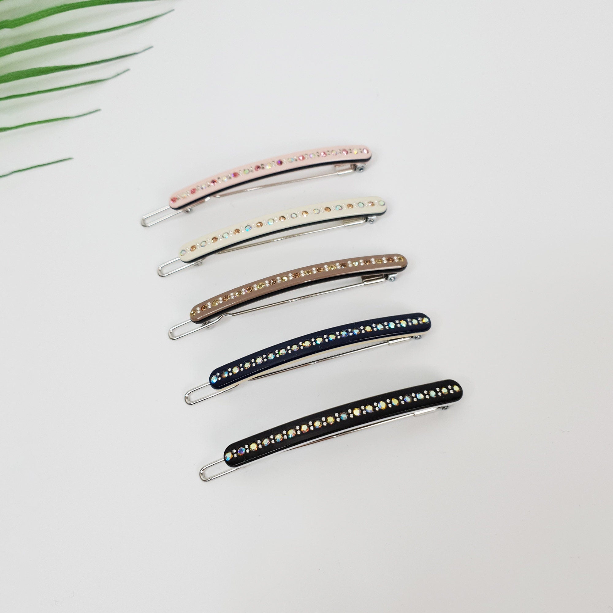 Cellulose acetate slim snap hair clips with rhinestone crystals. Minimalist barrette for side bangs. Sparkly hair accessory.  Five hair clips with rhinestones. The clips are in different colors: pink, white, brown, dark blue, and black.