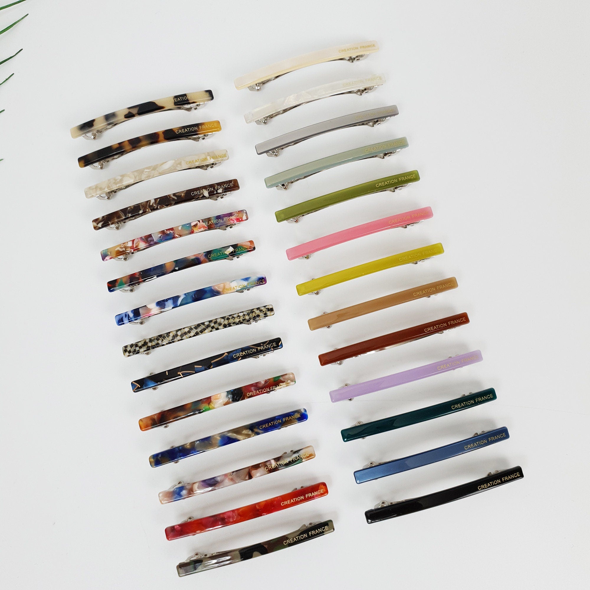 Slim cellulose acetate automatic barrettes in tortoise shell and colorful marble patterns. Thin 2.6 inch French style hair clips for side bangs. Minimalist hair accessories for women and girls.