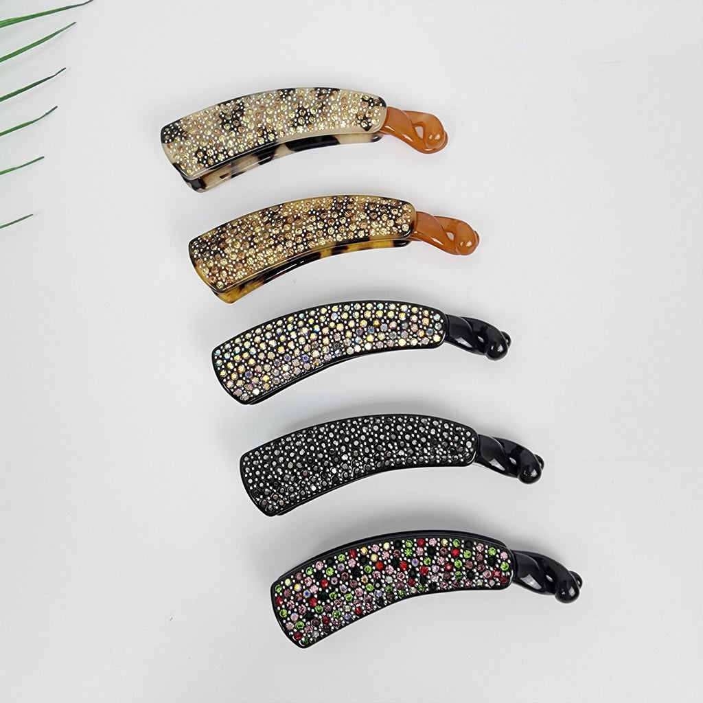 Small rhinestone banana hair clip tortoise shell and black cellulose acetate for half up hairstyles women and fine hair. Five hair clips with rhinestones. The clips are curved and have a black base. The rhinestones are different colors, including clear, black, and pink.