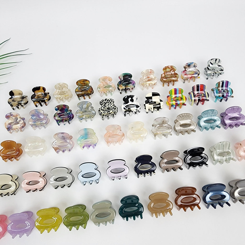 Tiny round cellulose acetate hair claw clips available in 51 colors including tortoise shell and pastel. 1 inch mini jaw clips for bangs, side hair, and toddlers.