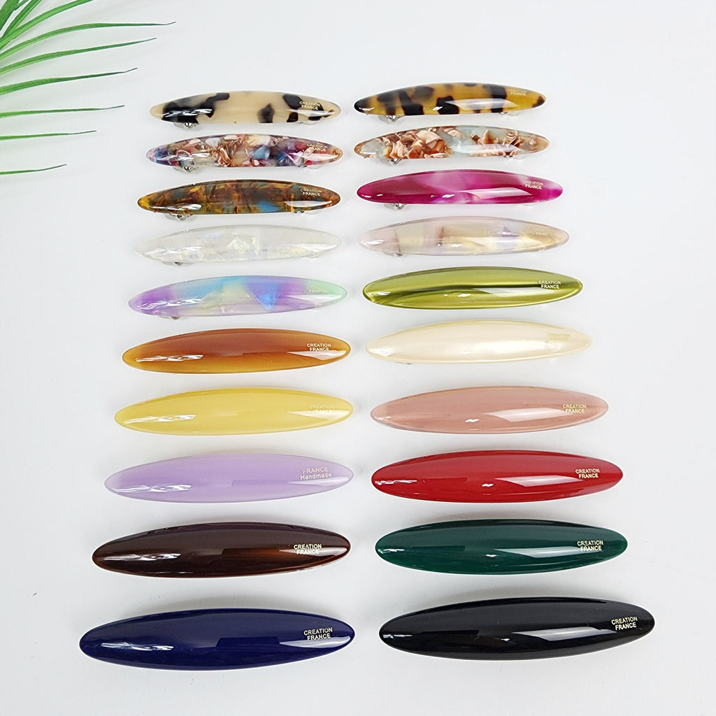 Cellulose acetate oval hair barrette in tortoise shell and solid colors, minimalist automatic clip for bangs and side hair styling.