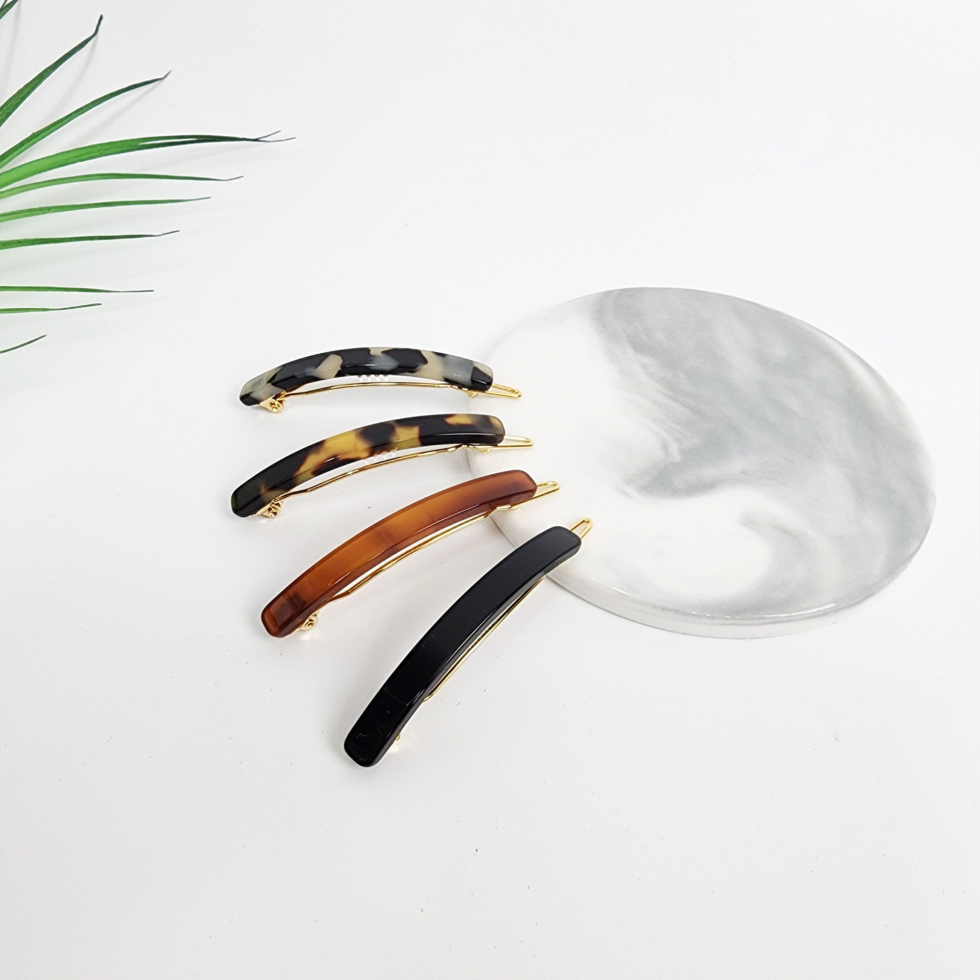 Slim rectangular cellulose acetate hair clips in tortoise shell and black, minimalist snap barrette for side hair and bangs styling.