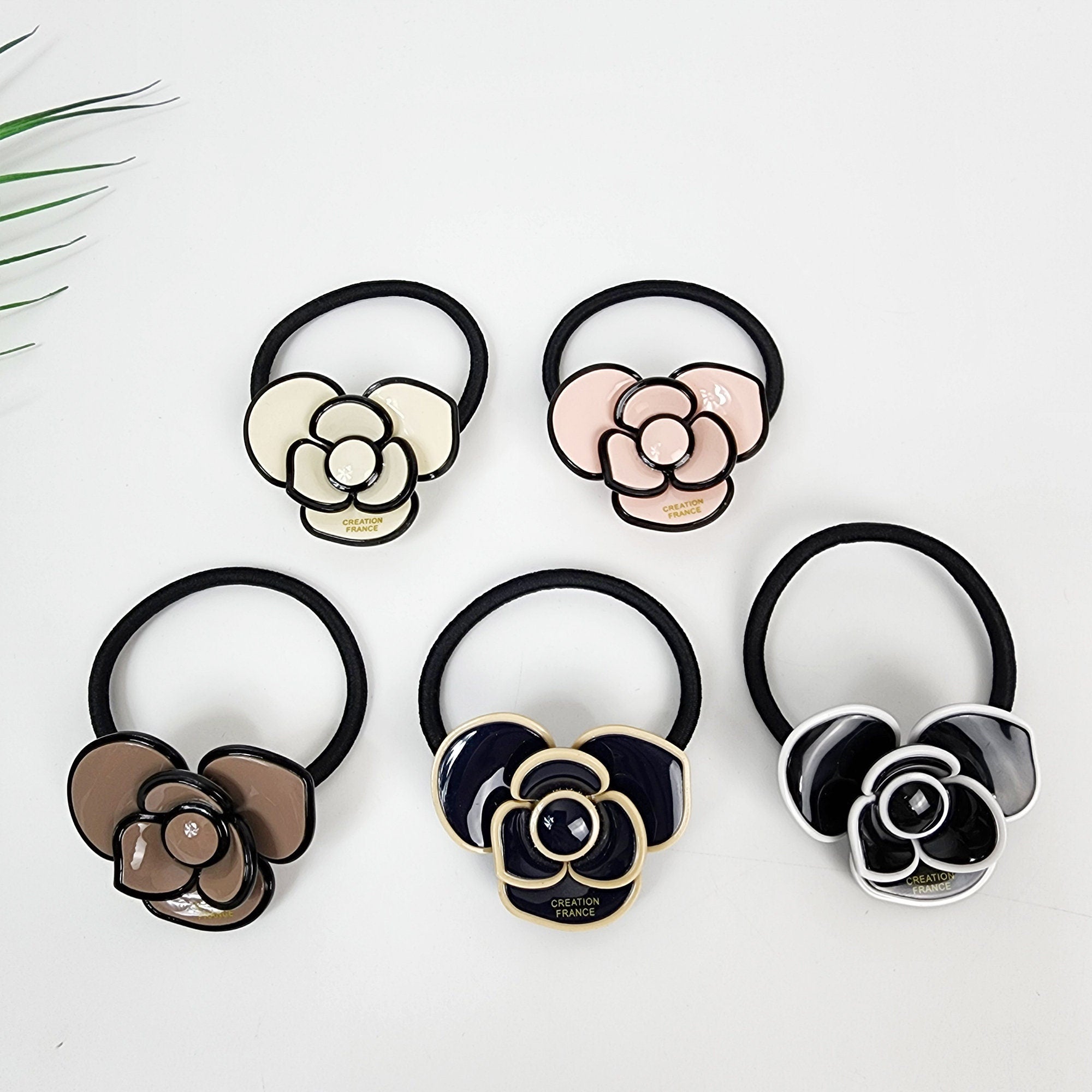 Glossy cellulose acetate camellia flower hair tie. Elegant pastel botanical ponytail holder with black elastic band for women birthday gifts. Korean fashion accessory.
