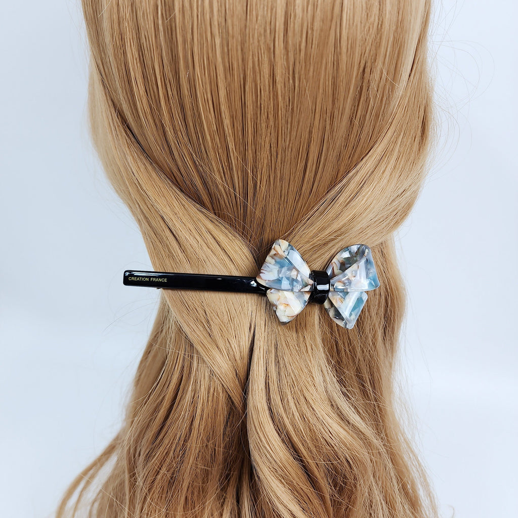 Cellulose acetate long slim barrette with bold butterfly ribbon accent in tortoise shell pattern. 4.6 inch french style automatic hair clip for women holding low ponytail or half up hairstyle.