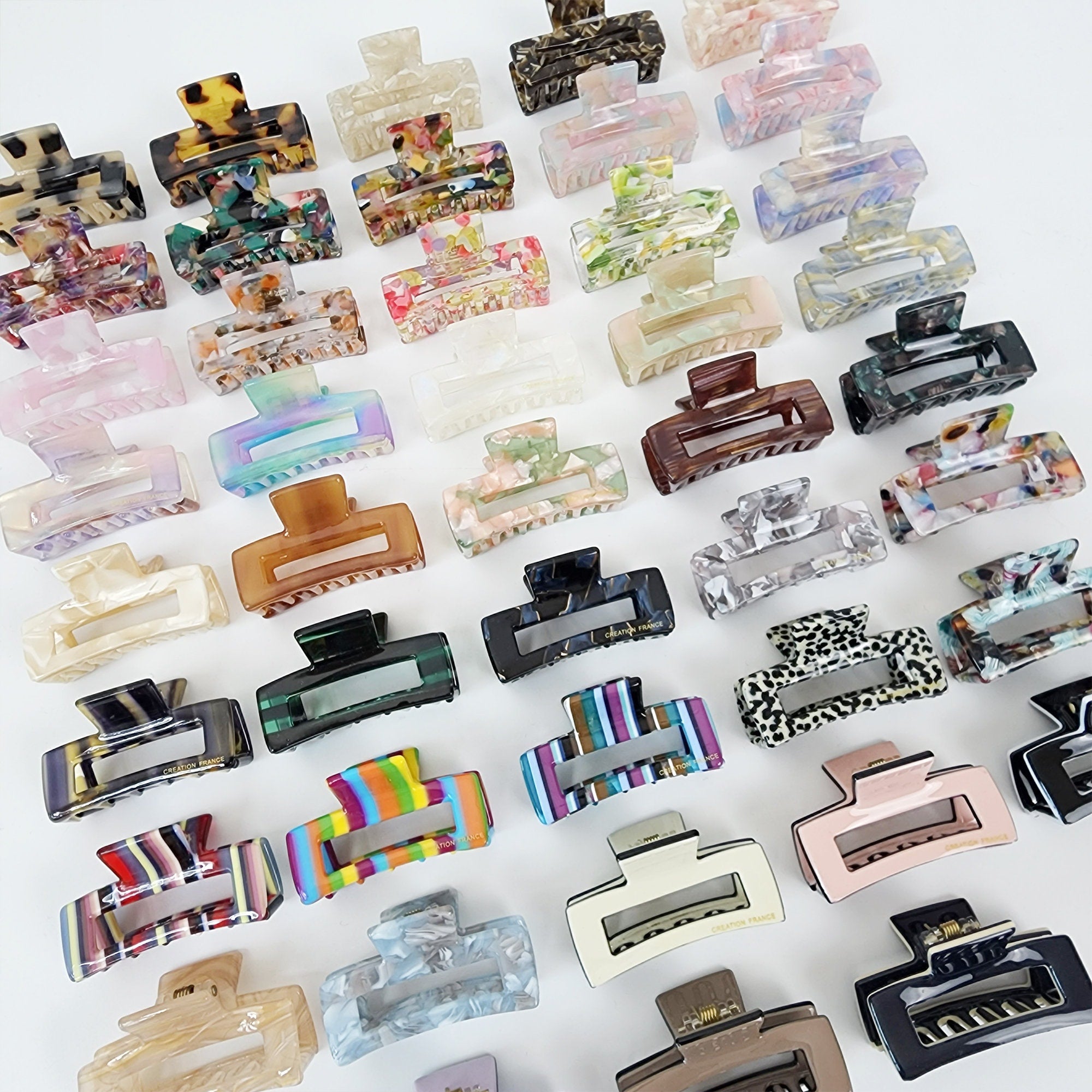 Cellulose acetate mini square hair claw clips in 47 colors including tortoise shell and pastel. Small rectangular jaw clips for bangs and side hair.