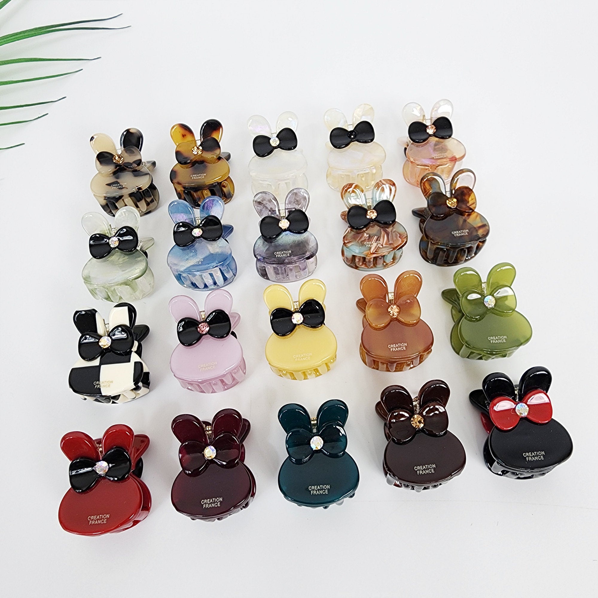 Cellulose acetate mini hair claw clip in bunny rabbit shape with rhinestone bow detail small jaw clip for bangs