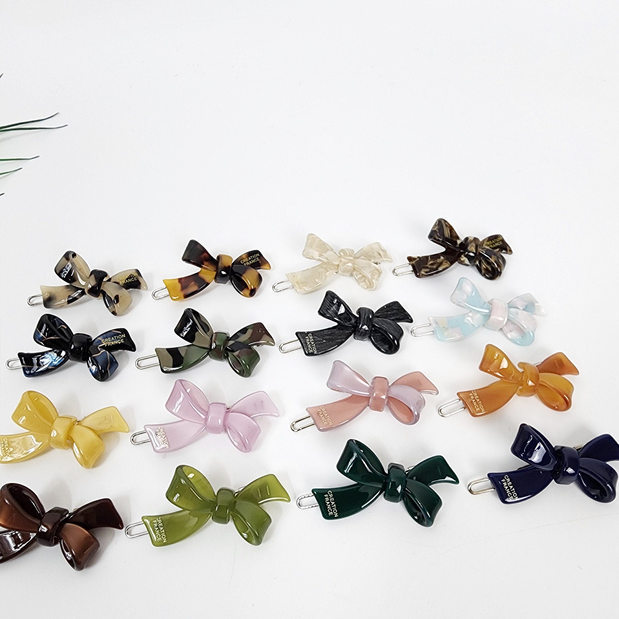 Tiny double bow cellulose acetate hair clips in 19 colors including tortoise shell and pastel. 1.8 inch snap clips for bangs and side hair.