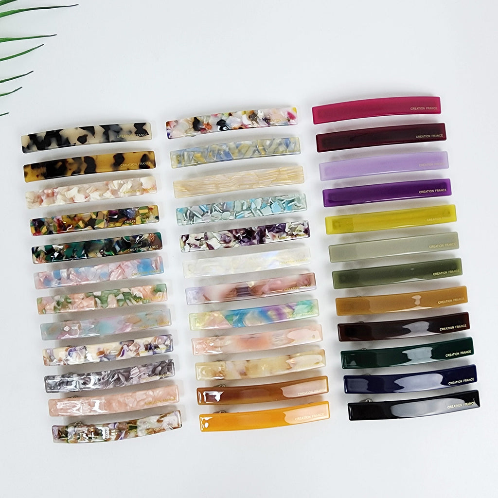 Slim rectangular cellulose acetate hair barrette available in tortoise shell and vibrant solid colors. Minimalist 3.1 inch automatic clip for styling bangs and side hair.