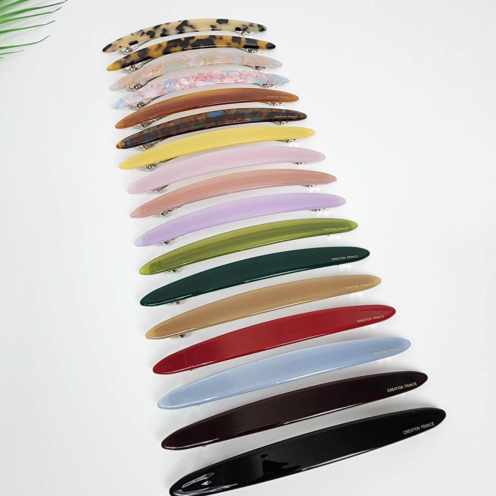 Cellulose acetate long oval barrette in tortoise shell and pastel colors featuring a sturdy automatic clasp for holding thick hair and ponytails.