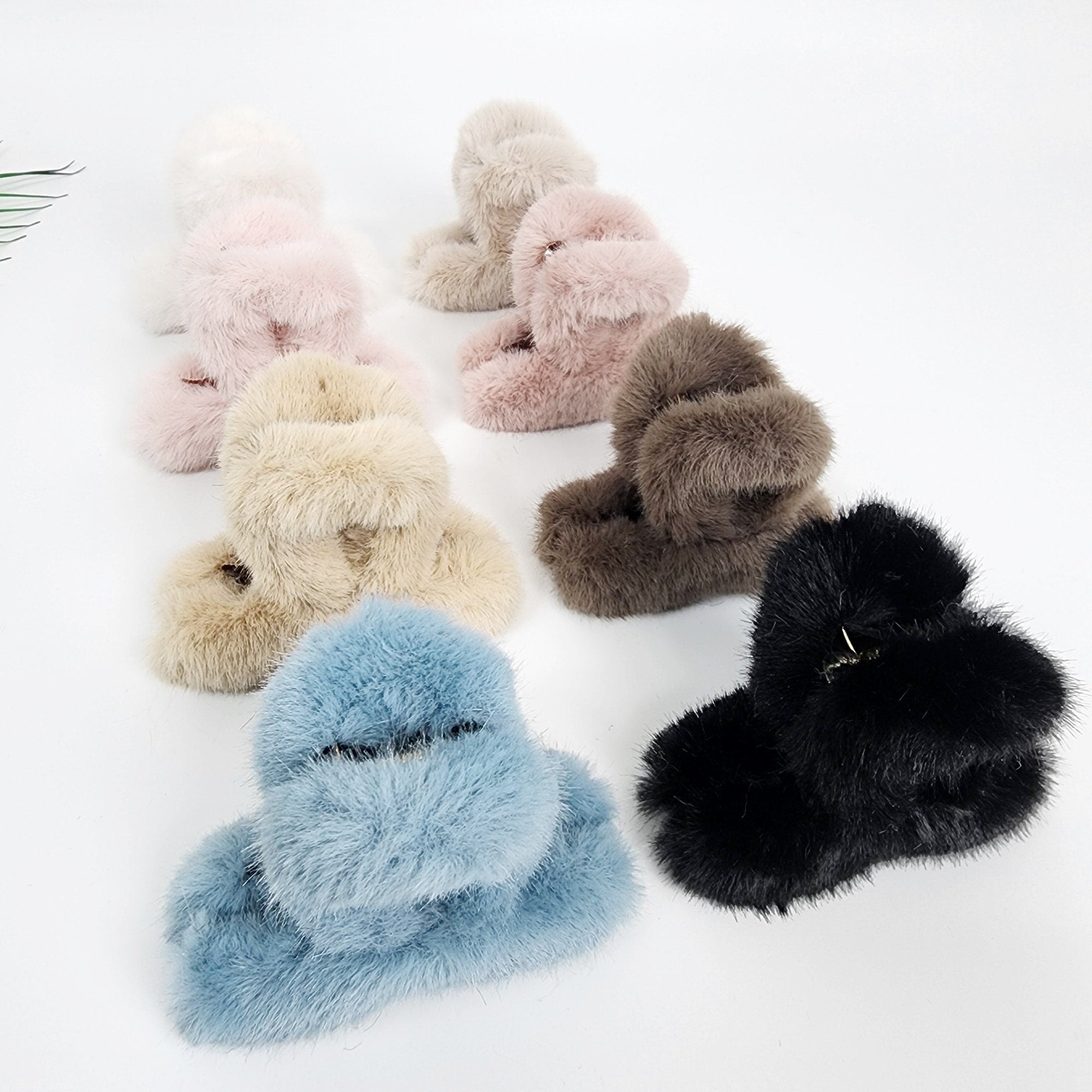Soft faux fur hair claw clip in pastel colors. Fuzzy 3.5 inch plush twisted knot jaw clamp for women. Winter hair accessory for half updos and cozy styles.