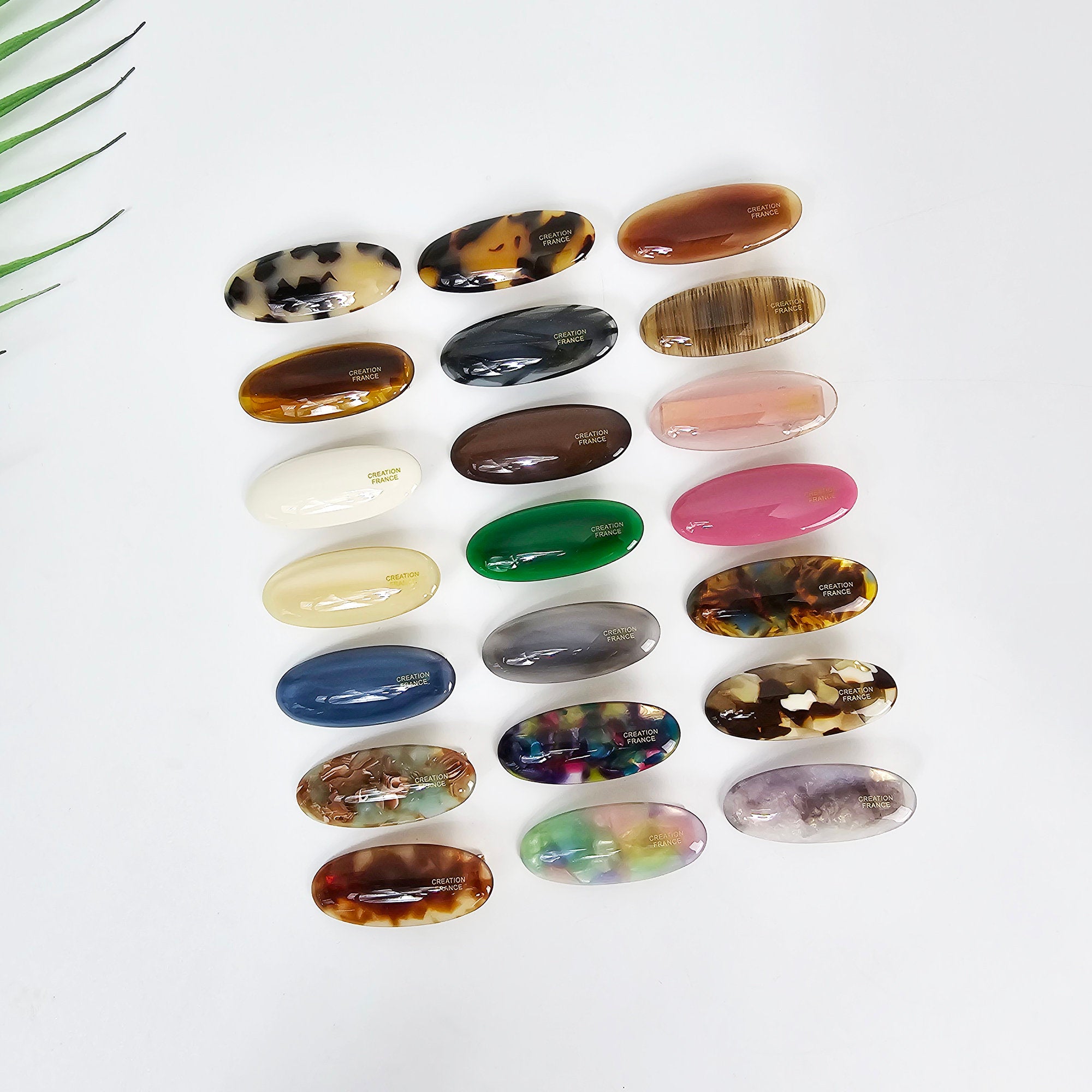 Miniature oval cellulose acetate hair clip in tortoise and pastel colors, 2 inch rounded geometric shape with alligator clasp for bangs, cute minimalist accessory.