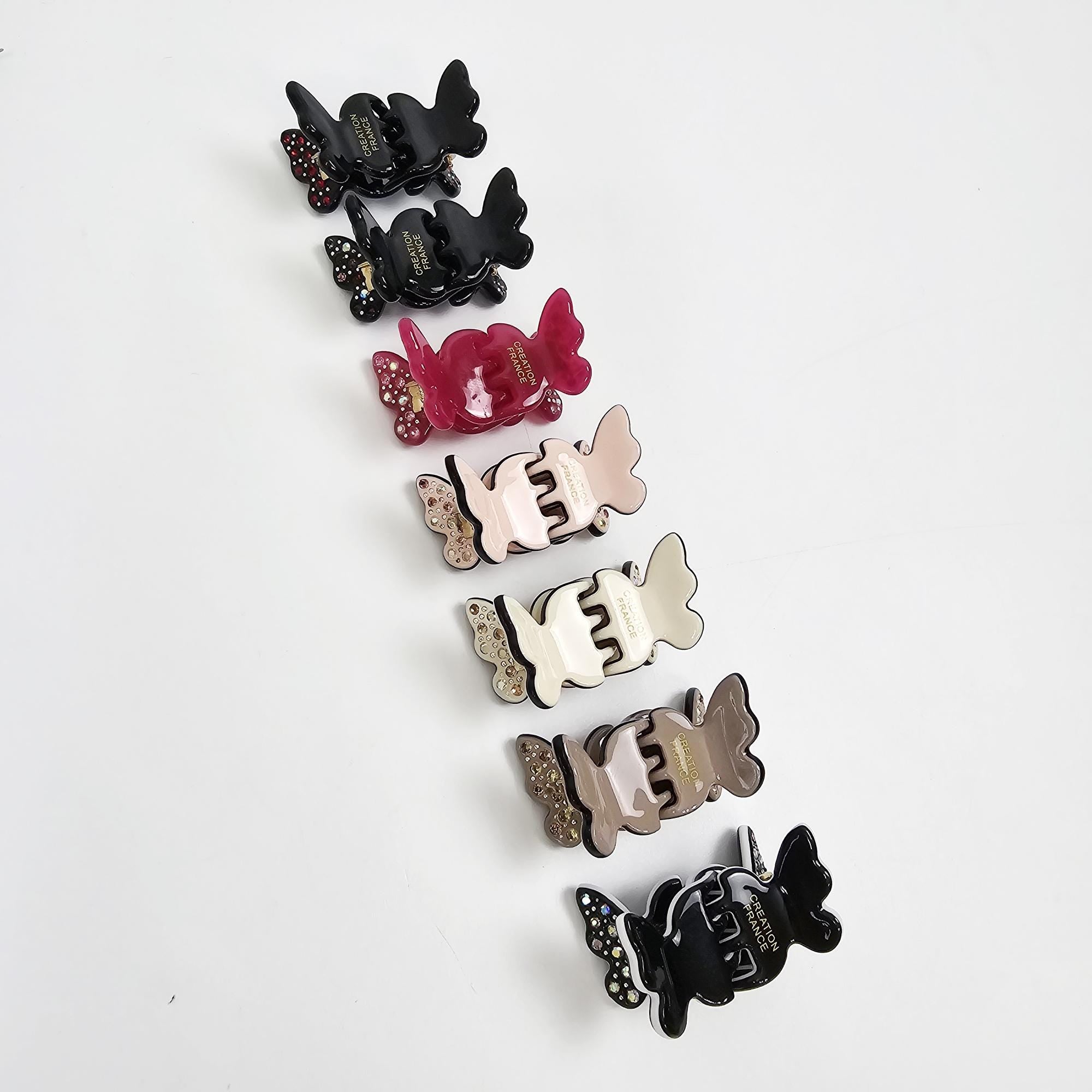 Set of 2 cellulose acetate mini butterfly hair claw clips with rhinestone accents. Cute small jaw clips for bangs and side hair styling.