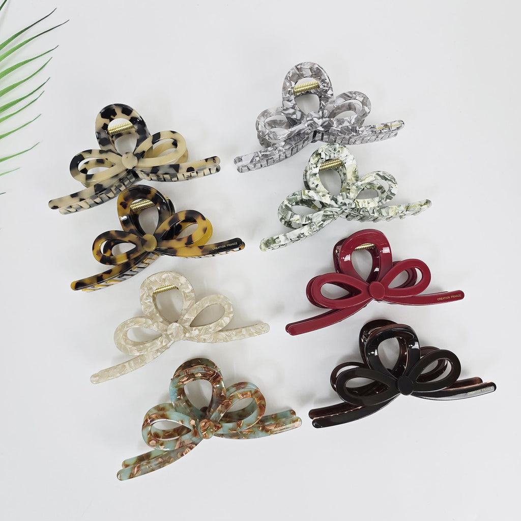 Cellulose acetate large ribbon twist claw clip in tortoise shell and marble colors for thick hair updos.
